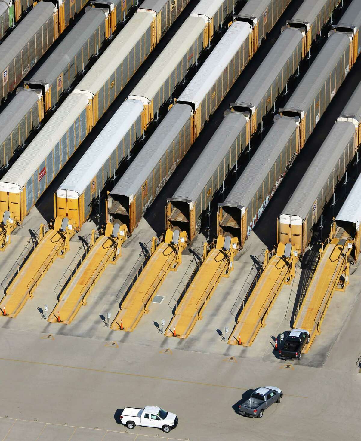 A Toyota Tundra pickup trucks, seen in a Jan. 18, 2013 aerial picture, are driven onto a rail car for delivery after being built at the Toyota Motor Manufacturing, Texas, Inc. plant in south Bexar County. The TMMTX plant, announced in 2003, now builds Tundra and Tacoma pickup trucks.