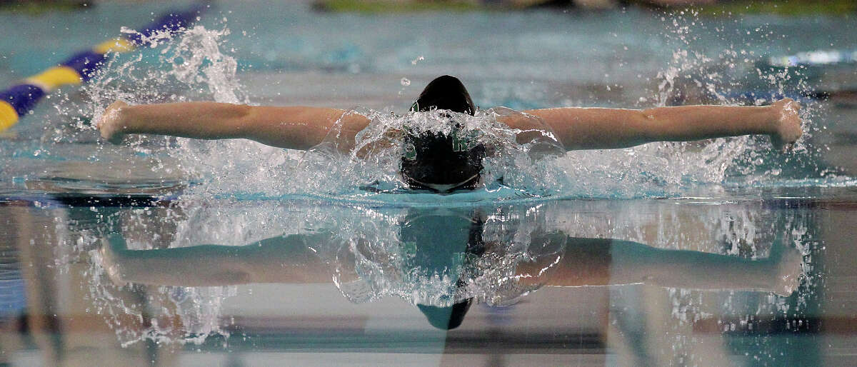 Reagan's Kristina Domaschofsky swims the 100-yard butterfly at the District 26-5A swim meet at Josh Davis Natatorium on Saturday, Feb. 2, 2013. Domaschofsky finished first with a time of 57.13.