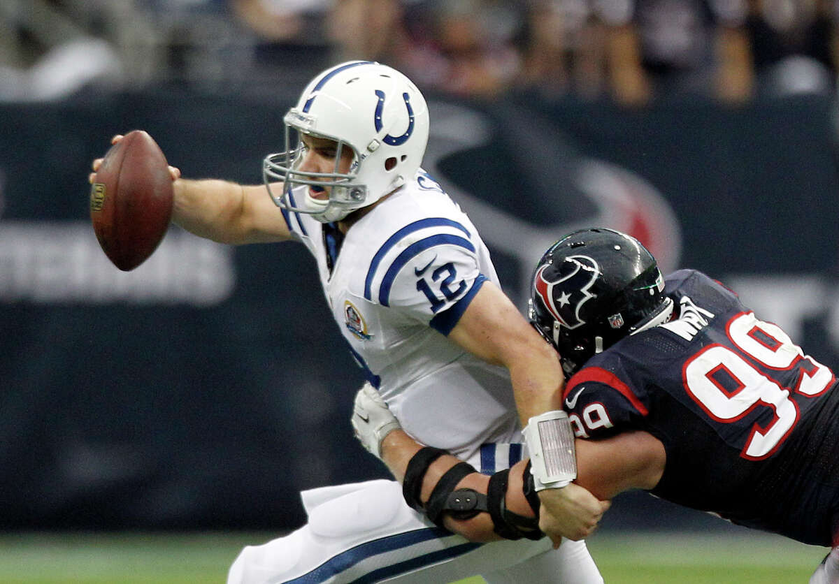 Texans defensive end J.J. Watt, right, makes Colts rookie Andrew Luck one of his 201/2 sacks this season.