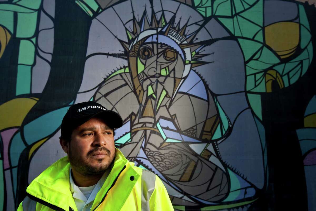 Houston mural artist Daniel Anguilu says he starts with circles when he makes a mural. Among his final touches are thick, spray-painted lines that give the mural a stained-glass look. Anguilus first used paint in his teen years, on buildings and rail cars.