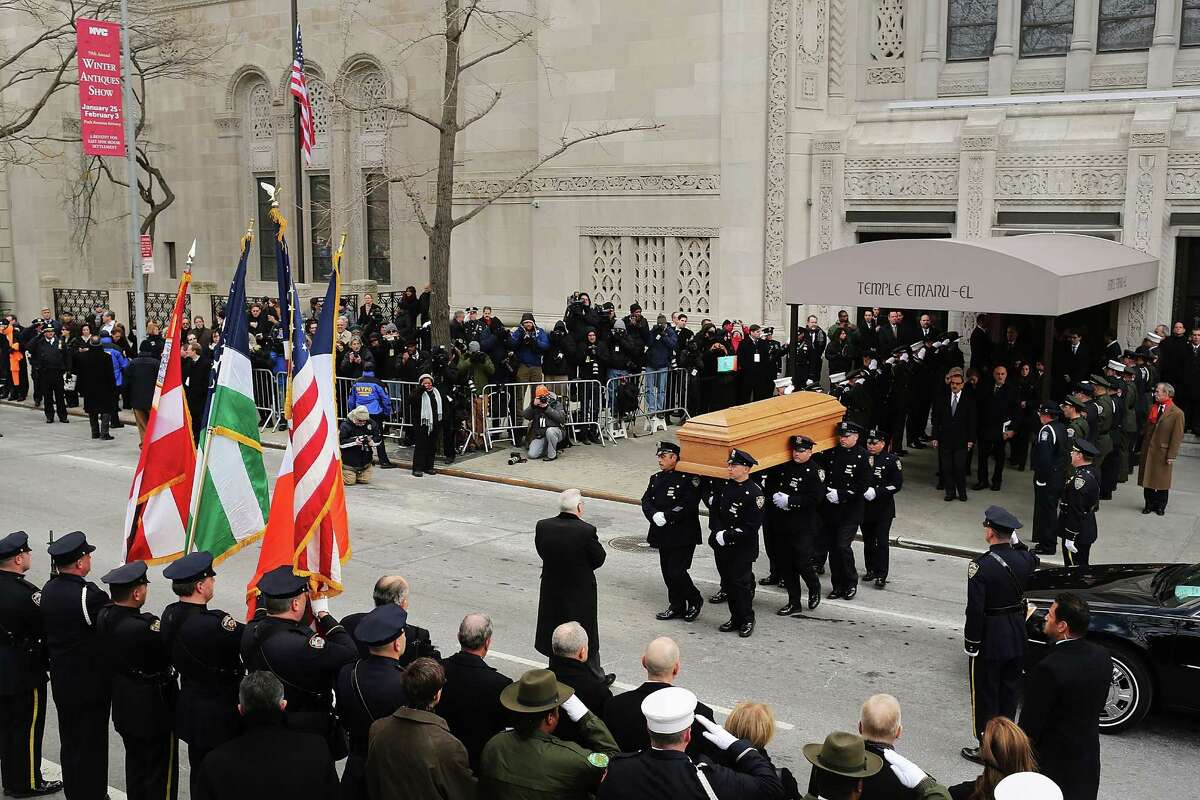 NEW YORK, NY - FEBRUARY 04: People watch as the casket of former New York City Mayor Ed Koch is brought out by members of the New York Police Department following funeral services at Manhattan's Temple Emanu-El on February 4, 2013 in New York City.The iconic former New York mayor passed away on February 1, 2013 in New York City at age 88. Ed Koch was New York's 105th mayor and ran the city from 1978-89. He was often outspoken and combative and has been credited with rescuing the city from near-financial ruin during a three-term City Hall run.
