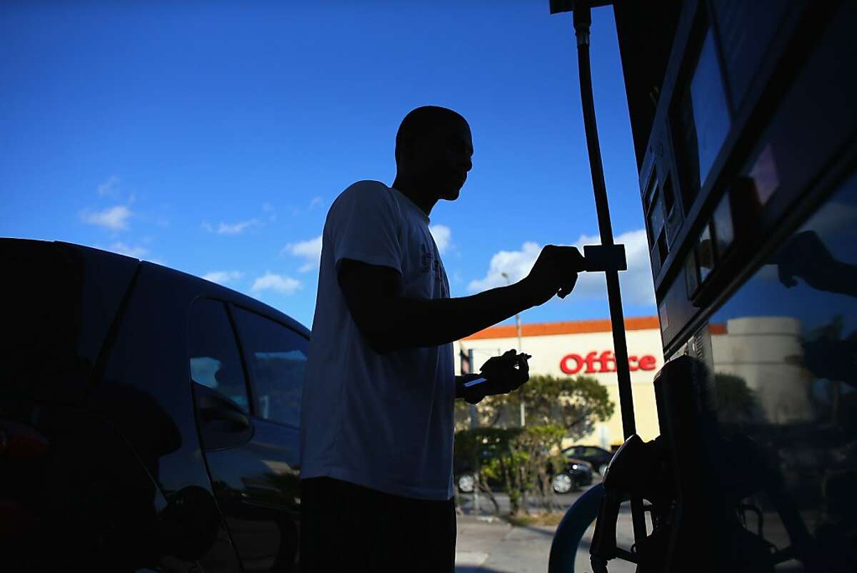 MIAMI, FL - FEBRUARY 04: Rennie Valius uses a gas station's pump to fill his vehicle with gas on February 4, 2013 in Miami, Florida. Reports indicate that gas pump prices are at their highest level on record for this period of the year and may be an indication that the year ahead may see even higher records. (Photo by Joe Raedle/Getty Images)