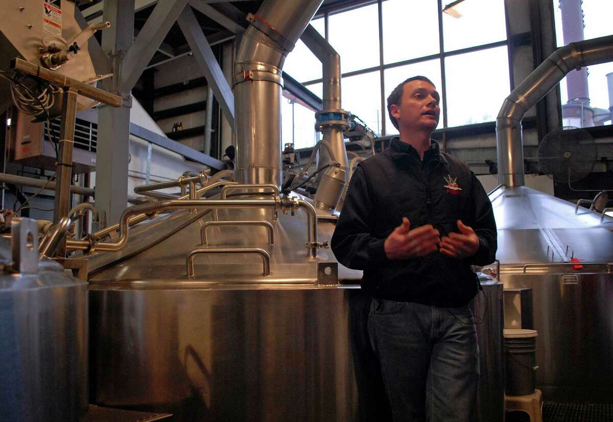 In this photo taken Jan 23, 2013, in Juneau, Alaska, Brandon Smith, the Alaskan Brewing Co.'s brewing operations and engineering manager, speaks to reporters about the company's new boiler system. The brewery has installed a unique boiler system that burns the company's spent grain the accumulated waste from the brewing process into steam which powers the majority of the plant's operations. (AP Photo/Joshua Berlinger)