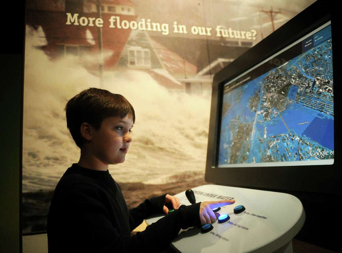 Liam Flanagan-Brown, 9 of Meriden, uses an interactive screen showing the rise in coastal flooding in the new global warming exhibit at the Peabody Museum in New Haven on Wednesday, January 30, 2013.