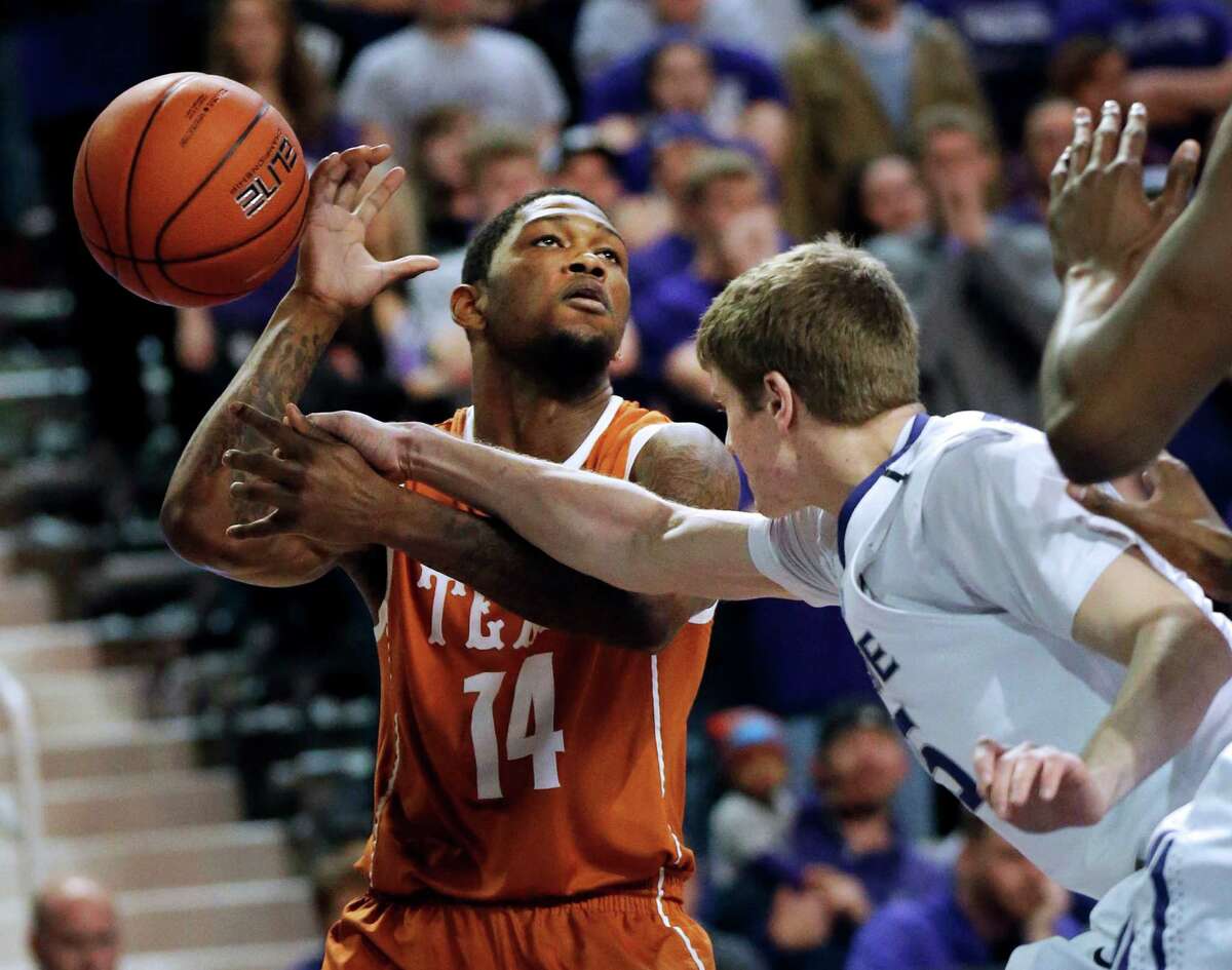 Kansas State guard Will Spradling (55) knocks the ball away from Texas guard Julien Lewis (14) during the first half of an NCAA college basketball game in Manhattan, Kan., Wednesday, Jan. 30, 2013. (AP Photo/Orlin Wagner)