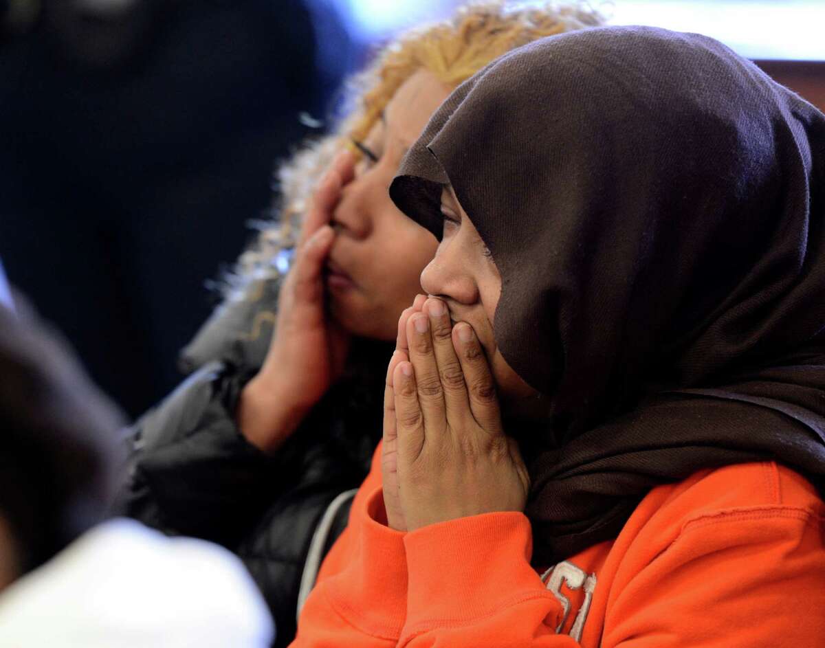 Roshana McArthur, right, the mother of the stabbing victim Takim Smith is comforted by her relative Charmine Chaney, left, Tuesday morning, Feb. 5, 2013, in Troy City Court in Troy, N.Y., during the arraignment of the defendants, Ahziarh Carter, 16, and Keith Ferguson, 17. They are charged with 2nd degree murder. (Skip Dickstein/Times Union)