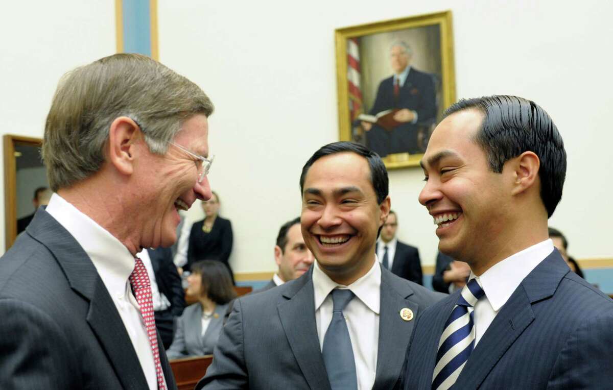 San Antonio, Texas Mayor Julian Castro, right, and his brother Rep. Joaquin Castro, D-Texas, center, talk with House Judiciary Committee member, Rep. Lamar Smith, R-Texas, all from San Antonio, on Capitol Hill in Washington, Tuesday, Feb. 5, 2013, prior to Mayor Castro testifying before the committee's hearing on America's Immigration System: Opportunities for Legal Immigration and Enforcement of Laws against Illegal Immigration. (AP Photo/Susan Walsh)