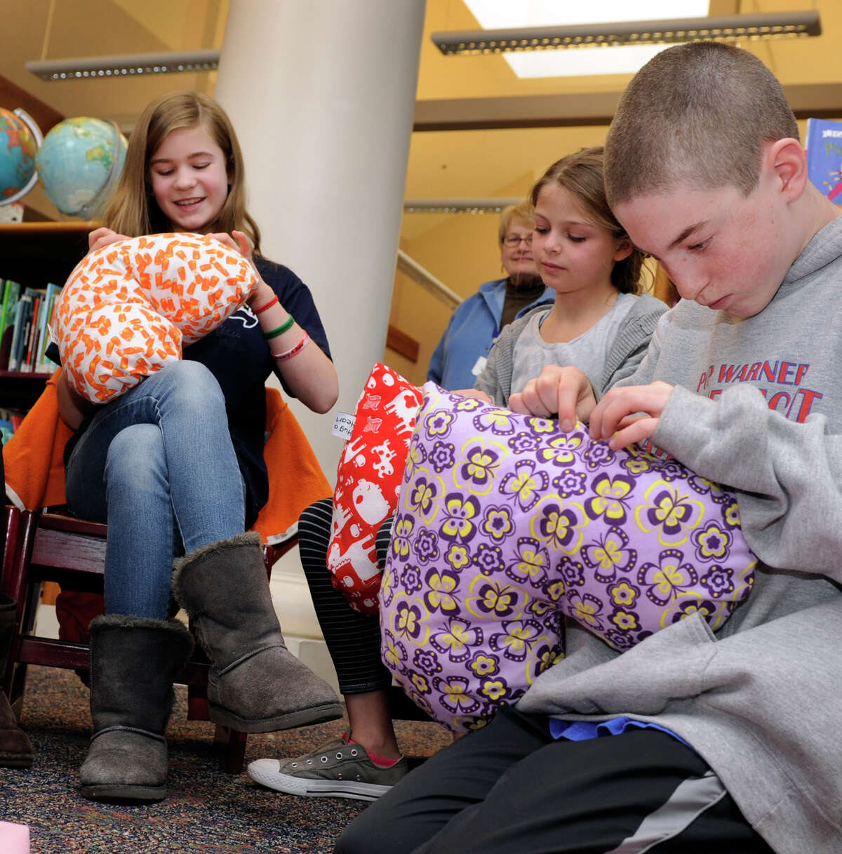 From left, Amelia Moschitta, Ryan Berlinger and Will Enright, all 11-year-old sixth-graders, do the final sewing on pillows that will be given to young cancer patients at Columbia Prebyterian Hospital in New York. This is the second annual "Matthew's Hearts of Hope 'Hug a Heart' Pillow Project" at the Sherman School, and the goal is 300 pillows. The project was started by Marie Hatcher, whose son Matthew was born with a congenital heart defect.