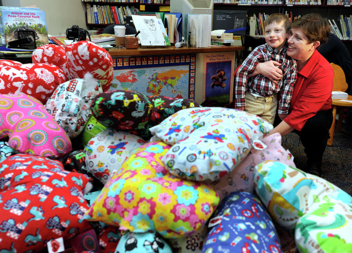 Marie Hatcher and her son Matthew look at some of the pillows that were made for the second annual "Matthew's Hearts of Hope 'Hug a Heart' Pillow Project" at the Sherman School on Tuesday, Feb. 5, 2013. Matthew was born with a congenital heart defect. Marie Hatcher has been working to raise awareness of the disease.