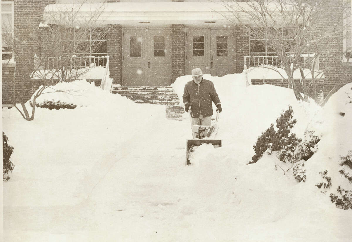 Man clears Dolan School's front walk in Stamford, Conn. during the blizzard of 1978.