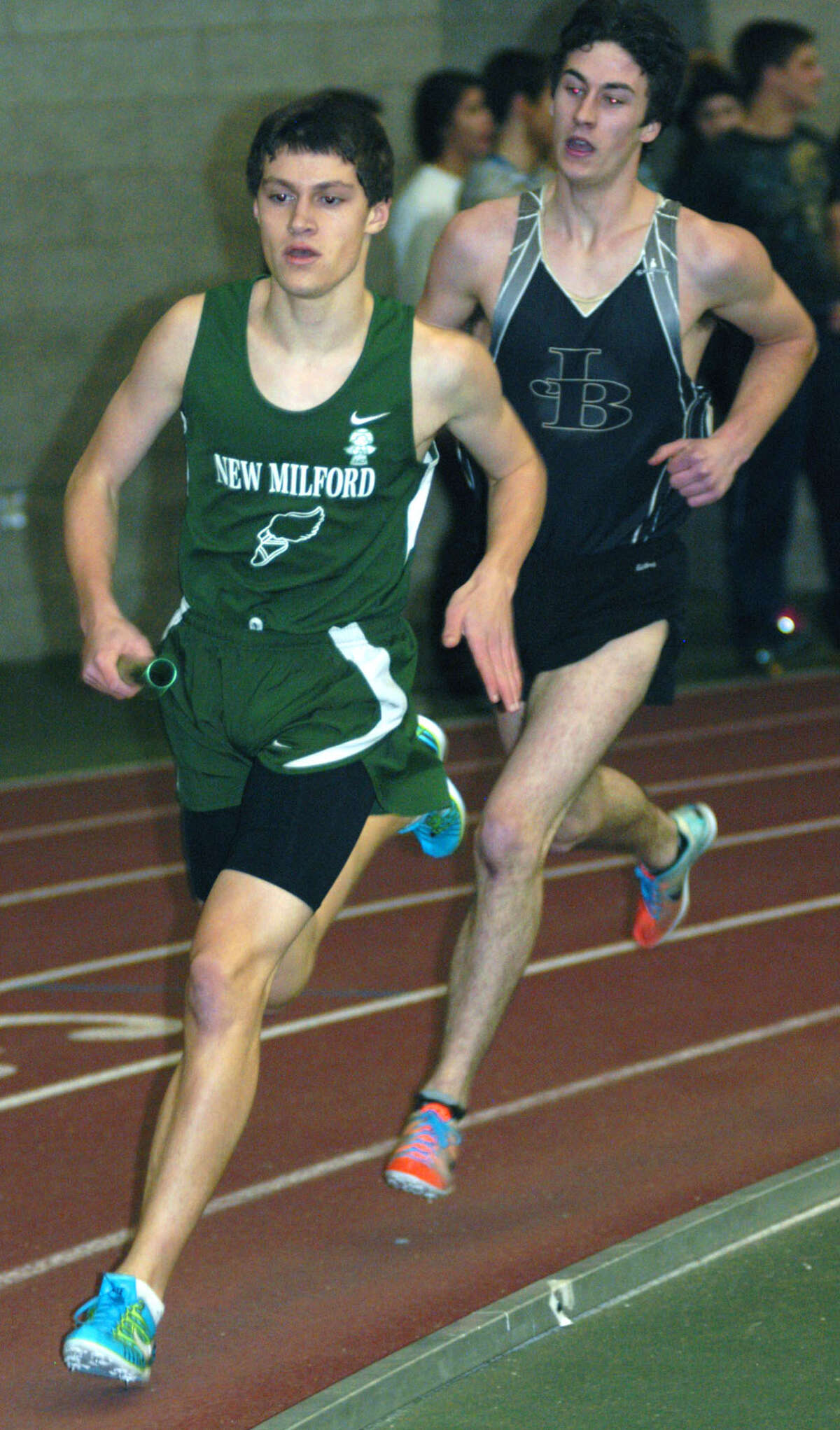 The Green Wave's Hugh Sichel turns the corner for home on his leg of the 4 x 800-meter relay for New Milford High School boys' indoor track during the South-West Conference championship meet at Hillhouse High School in New Haven. Feb. 2, 2013