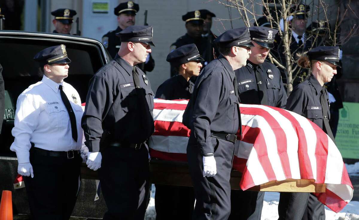 Pallbearers carry the casket of former Buffalo Police Officer Patricia Parete during funeral services in Buffalo, N.Y., Wednesday, Feb. 6, 2013. Parete, was shot and paralyzed while on duty six years ago. She died last Saturday at her Niagara County home. Parete and another Buffalo police officer were shot in December 2006 after responding to a fight at a convenience store. One of the bullets hit Parete in the chin and lodged in her spine. The other officer also survived. The man who shot them, Varner Harris Jr., is serving 30 years to life in a state prison.