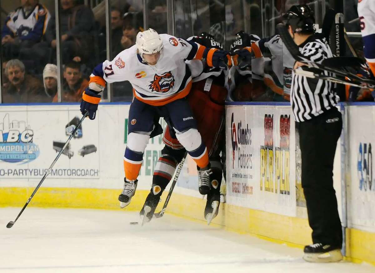 Bridgeport Sound Tigers host the Hartford Wolf Pack at the Arena at Harbor Yard in Bridgeport, CT on Saturday, Dec. 26, 2009. Sound Tigers #71 Mark Katic catches some air along with Wolf Pack #19 Evgeny Grachev./ Shelley Cryan for the CT Post