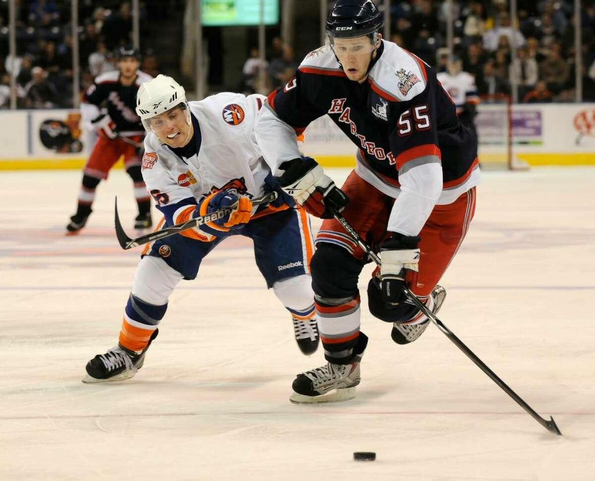 Bridgeport Sound Tigers host the Hartford Wolf Pack at the Arena at Harbor Yard in Bridgeport, CT on Saturday, Dec. 26, 2009. Sound Tiger #55 Pascal Morency vies for the puck with Wolf Pack #55 Nigel Williams./ Shelley Cryan for the CT Post