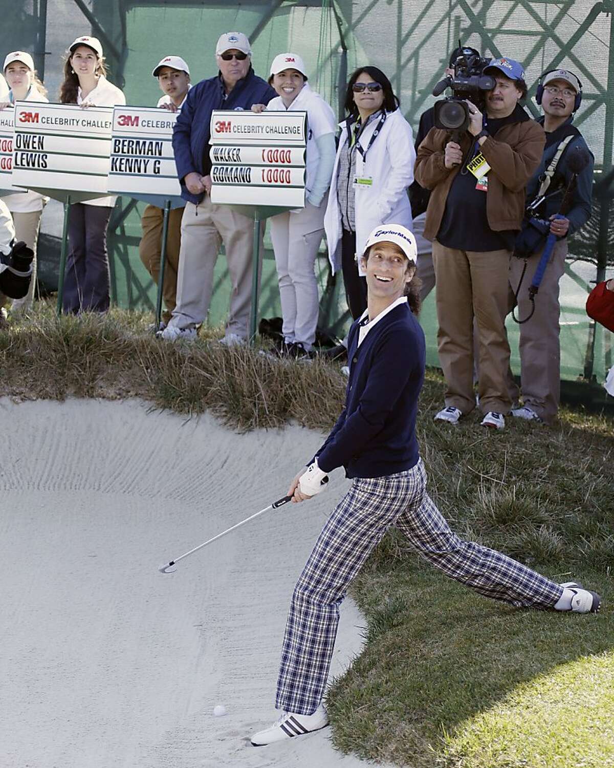 Musician Kenny G prepares to hit out of a bunker onto the 17th green of the Pebble Beach Golf Links during the celebrity challenge event of the AT&T Pebble Beach Pro-Am golf tournament on Wednesday, Feb. 6, 2013, in Pebble Beach, Calif. (AP Photo/Ben Margot)