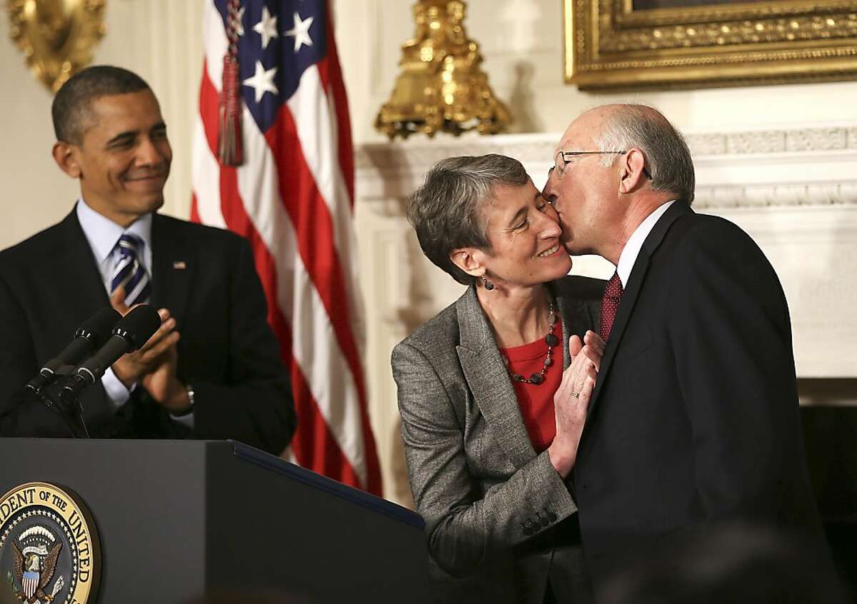 President Barack Obama applauds as Secretary of the Interior Ken Salazar gives Sally Jewell a kiss on the cheek during a news conference in the State Dining Room in the White House, in Washington, Feb. 6, 2013. Obama selected Jewell, the chief executive of Recreational Equipment Inc., to lead the Interior Department on Wednesday. (Doug Mills/The New York Times)