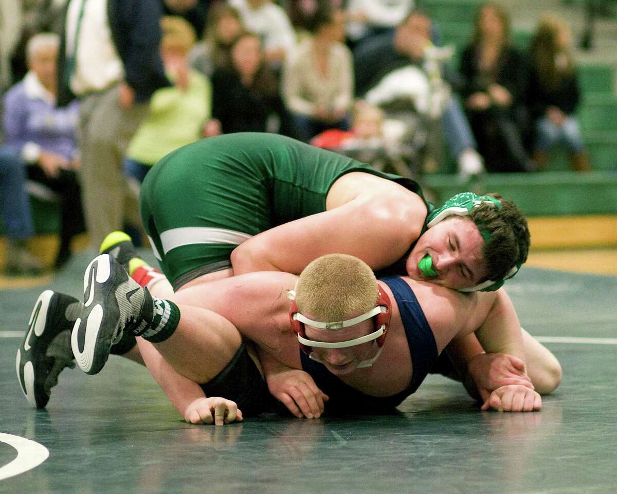 New Milford's Rob Tozzi, top, edged New Fairfield's Ryan Tharas, 7-6. in a battle of 220-pounders Wednesday night at New Milford High School.