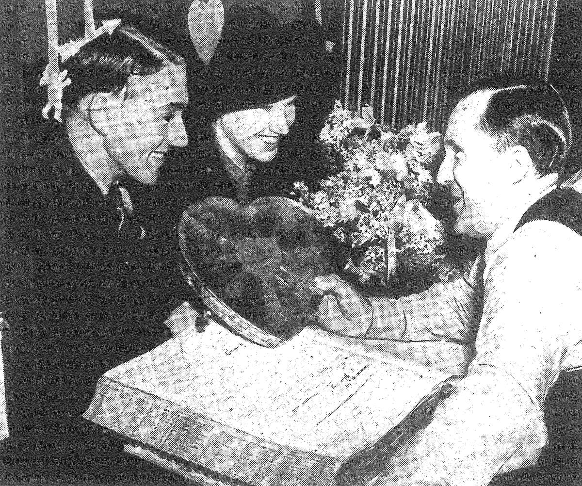 S.H. Wernette, marriage license clerk, got sentimental Monday, decorating his cage and presenting a box of heart candy to Roy A. Hardin of Temple and Mary Louise Casey of Hot Wells, the first couple obtaining a license on Valentine's Day. Others got a sack of candy from the clerk's office. Published in the San Antonio Light Feb. 14, 1938.