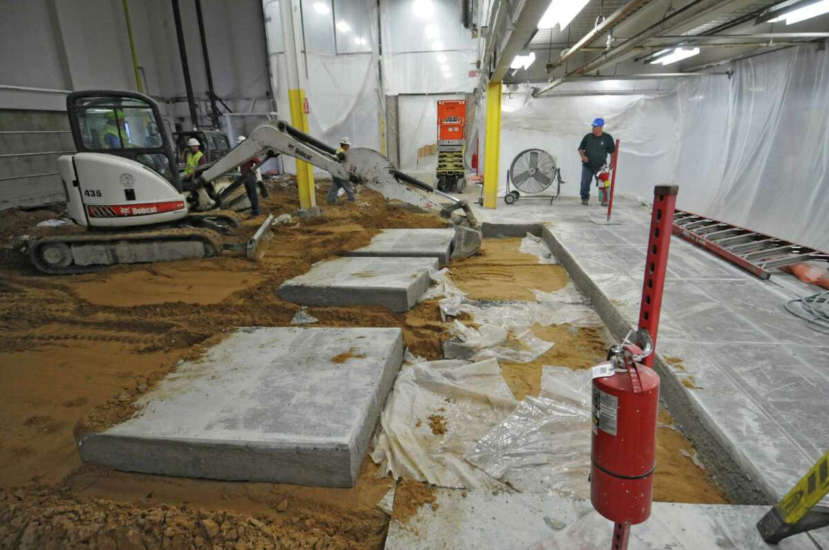 Workers remove the concrete floor of the old paper storage room as part of preparations for the new press at the Times Union, on Wednesday June 27, 2012 in Colonie, NY. (Philip Kamrass / Times Union)