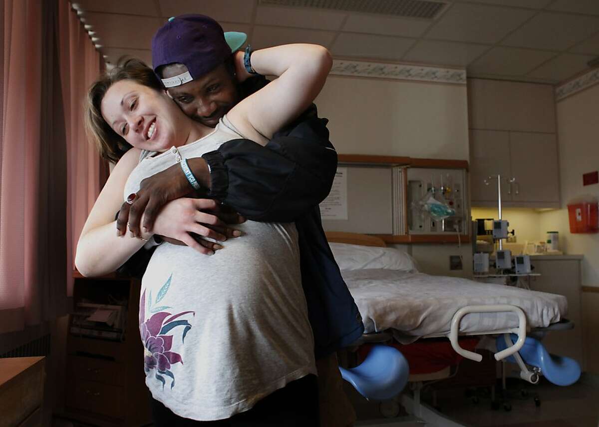 Caroline, 24, and Deon, 32 stand in a delivery room in the perinatal unit at San Francisco General Hospital, Monday, Feb. 4, 2013, in San Francisco, Calif. They are a part of San Francisco General Hospital's clinic known as PRO MEN, Positive Reproductive Outcomes for Men, which is designed toward helping HIV positive couples with having children. They are excepting their first child, a girl on February 20.