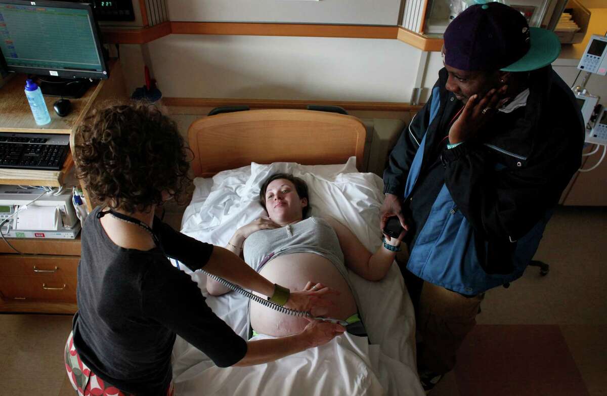 Dr. Deborah Cohan uses an ultra sound machine so that Caroline, 24, and her boyfriend Deon, 32, can hear their baby’s heart beat in the perinatal unit at San Francisco General Hospital in February 2013. The couple is a part of San Francisco General Hospital’s clinic known as PRO MEN, Positive Reproductive Outcomes for Men, which helps HIV-positive couples have children.