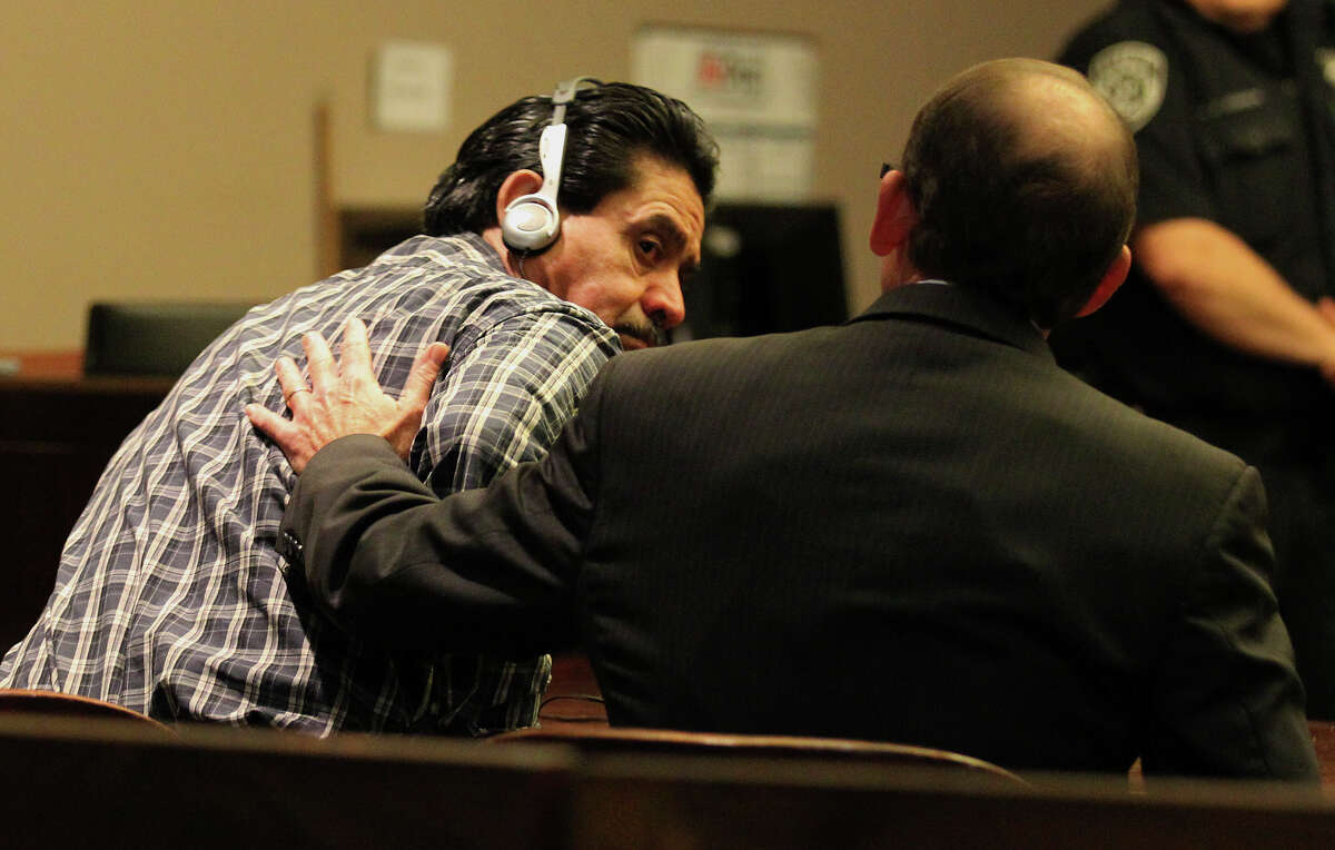 Murder defendant Juan Cavalos (left) receives a pat on the back from defense attorney Scott McCrum after Cavalos was aquitted for the murder of a fellow drifter at the 437th District Court on Thursday, Feb. 7, 2013.