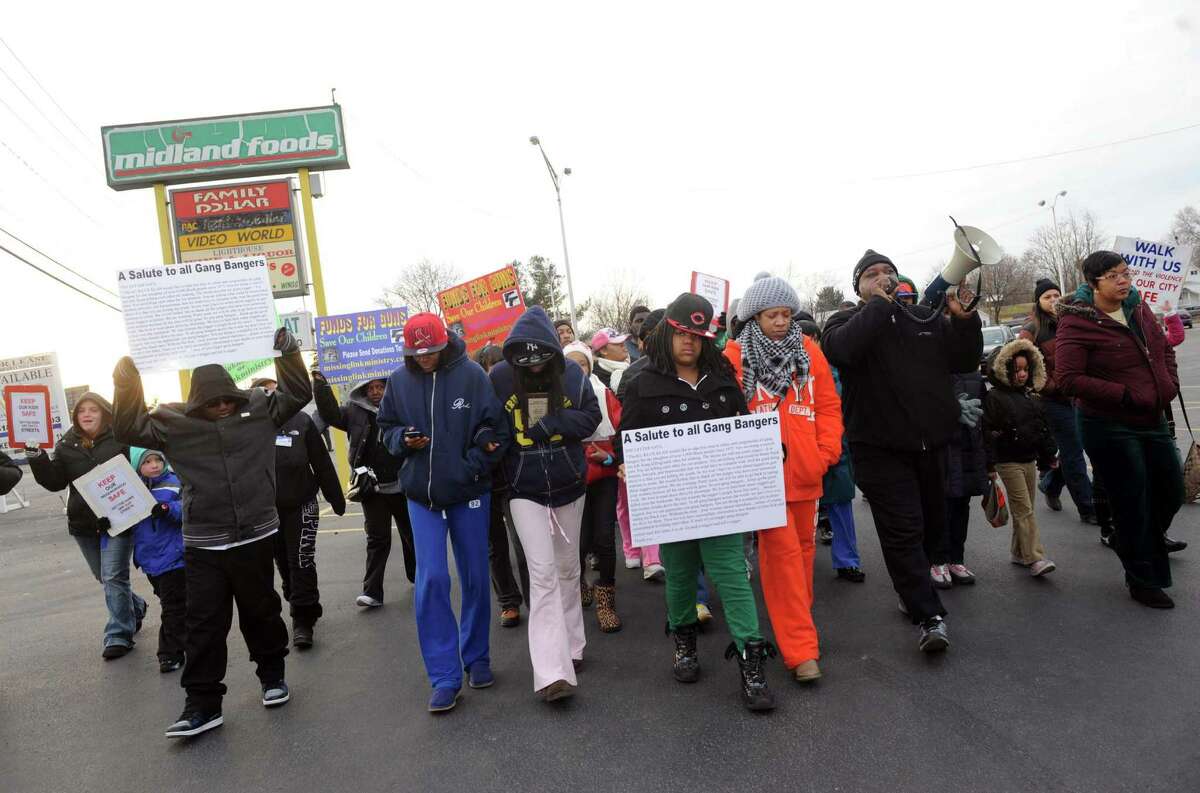 Rev. Willie Bacote, right, leads a stop the violence rally and march on Thursday Feb. 7, 2013 in Troy, N.Y. .(Michael P. Farrell/Times Union)