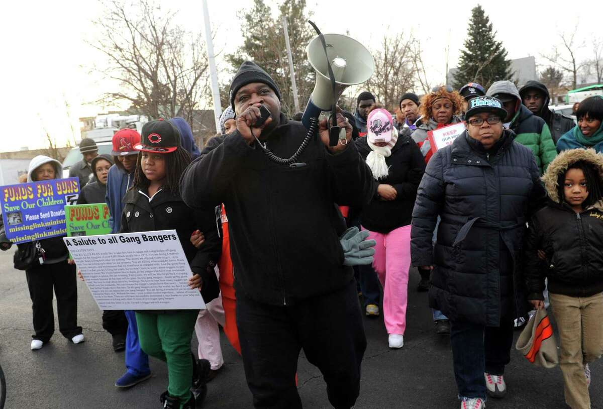 Rev. Willie Bacote leads a stop the violence rally and march on Thursday Feb. 7, 2013 in Troy, N.Y. .(Michael P. Farrell/Times Union)