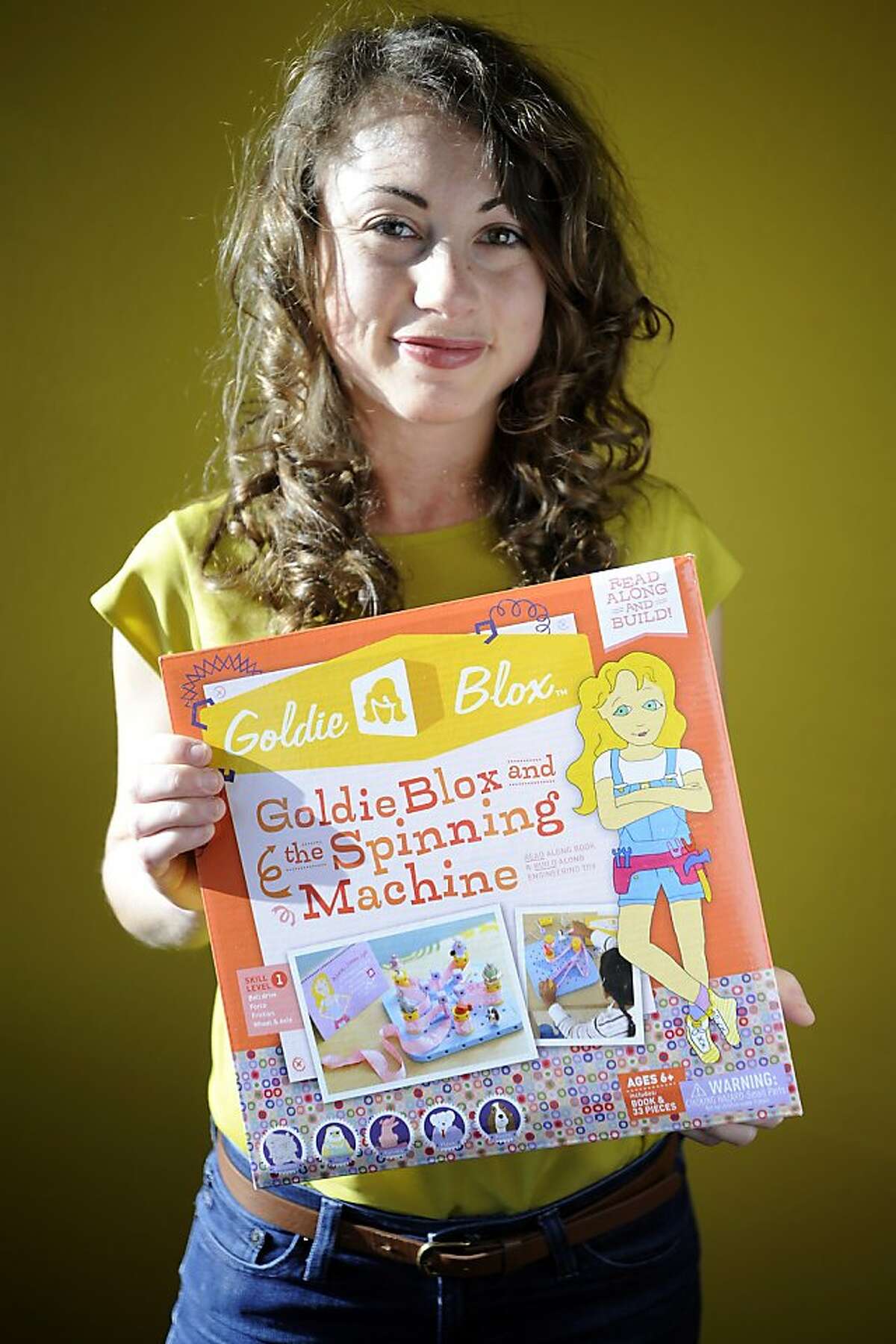 Debbie Sterling holds an example set of her toy, Goldie Blox and the Spinning Machine, at her new office space in Oakland, CA Wednesday February 6th, 2013. Stanford-educated engineer Debbie Sterling has created Goldie Blox, a construction toy and book series with character figurines, to help girls realize that science and engineering are fun.