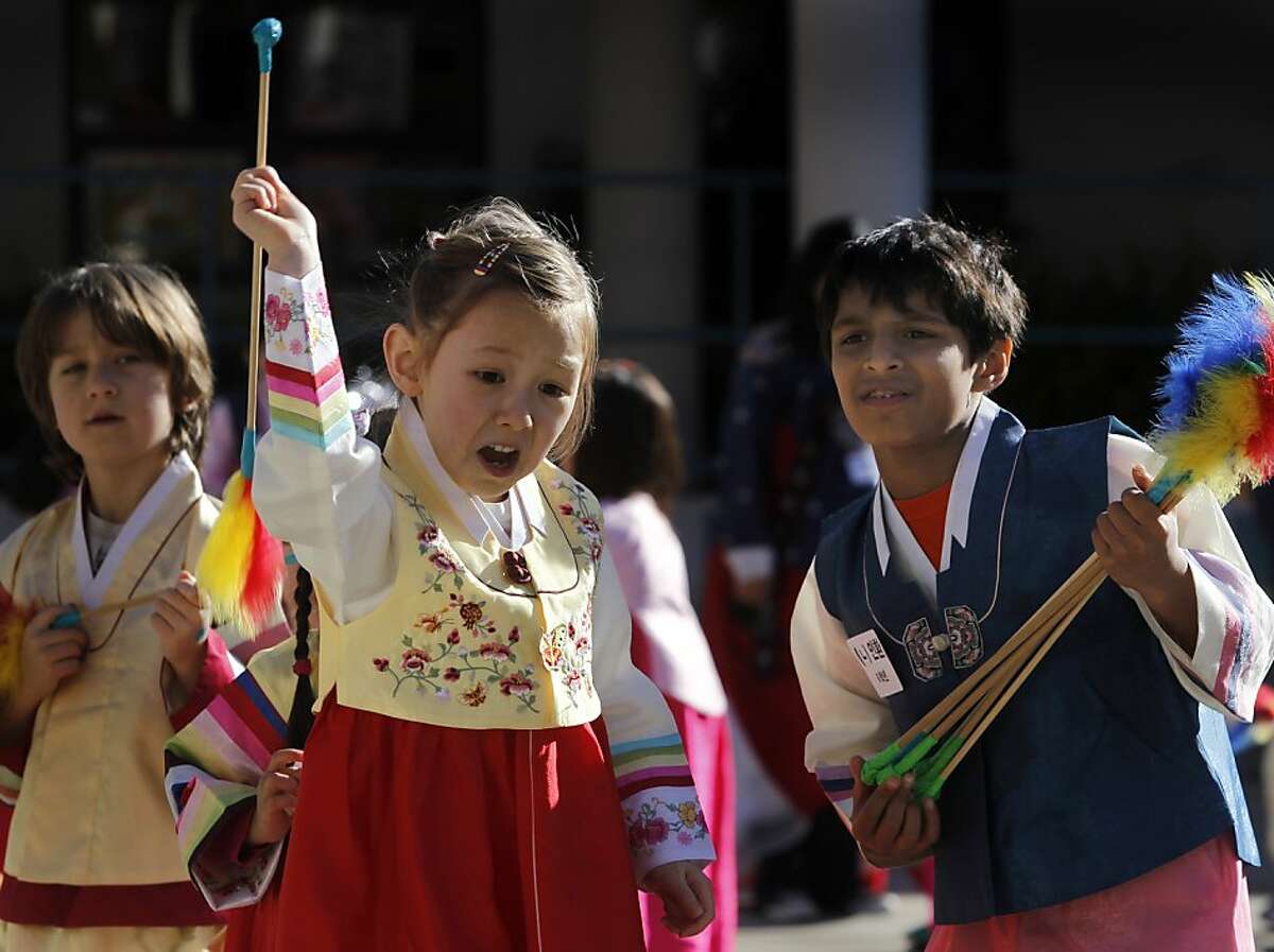 Simone Willets tosses an arrow while playing a game of tuho, with help from her classmate Adrien Stroumza (right), during a celebration of Seol Nal, the Korean Lunar New Year, at the Claire Lilienthal School in San Francisco, Calif. on Friday, Feb. 8, 2013. Students in the Korean-immersion program wore traditional hanbok outfits and participated in a variety of activities to celebrate the lunar new year, which begins Sunday.
