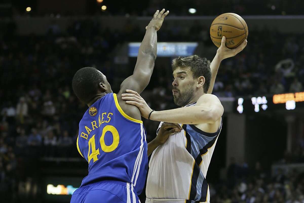 Memphis Grizzlies' Marc Gasol, right, of Spain, tries to pass over Golden State Warriors' Harrison Barnes (40) during the second half half of an NBA basketball game in Memphis, Tenn., Friday, Feb. 8, 2013. Gasol scored 20 points in the Grizzlies' 99-93 victory over the Warriors. (AP Photo/Danny Johnston)