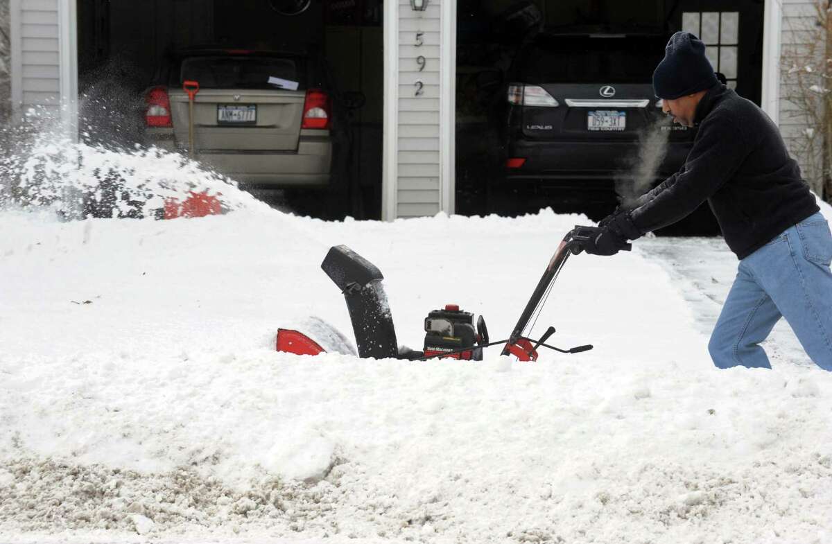 Stan Hansen clears his driveway of overnight snow on Saturday Feb. 9, 2013 in Delmar, N.Y. .(Michael P. Farrell/Times Union)