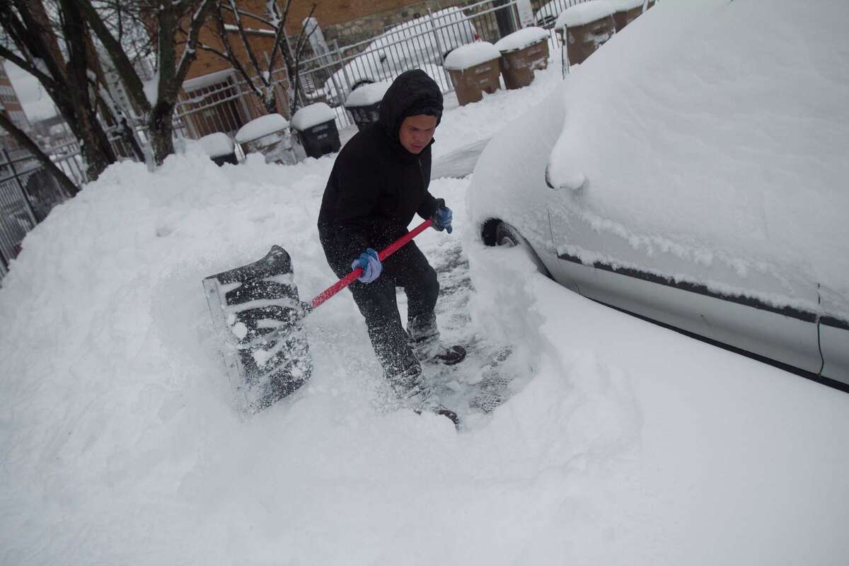 Danny Escobar clears a path in a parking lot on Stamford's West Side dig out from the blizzard on Saturday, Feb. 9, 2013.