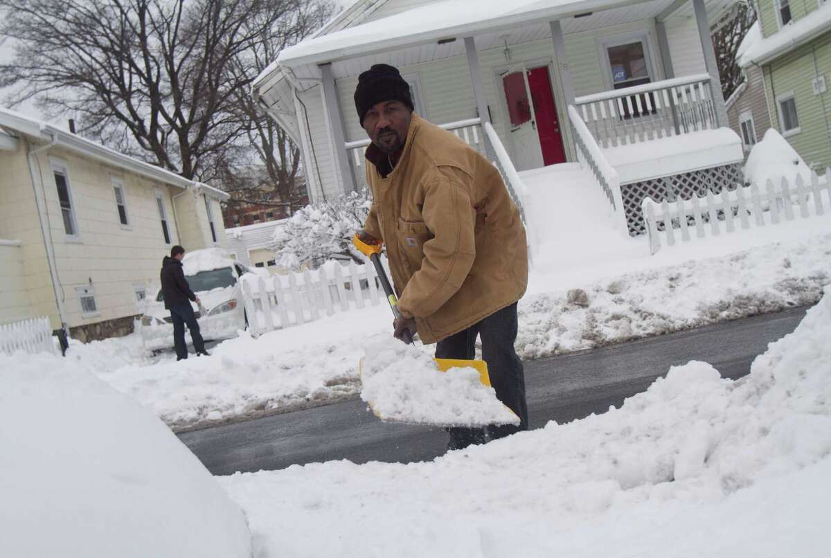 Nigel Pryce, a resident of Stamford's West Side digs out from the blizzard on Saturday, Feb. 9, 2013.
