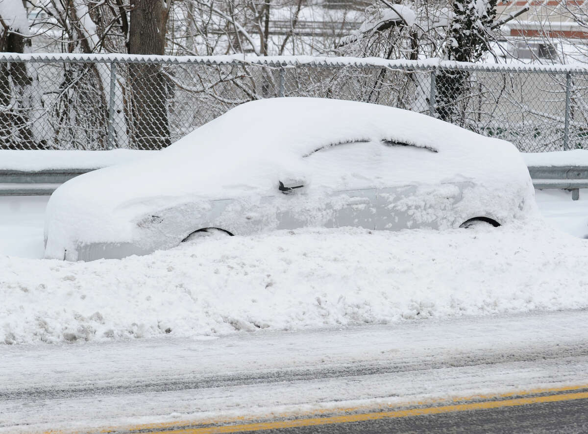 A car covered with snow on Byram Road during the aftermath of the blizzard that hit Greenwich, Conn., Saturday morning, Feb. 9, 2013.