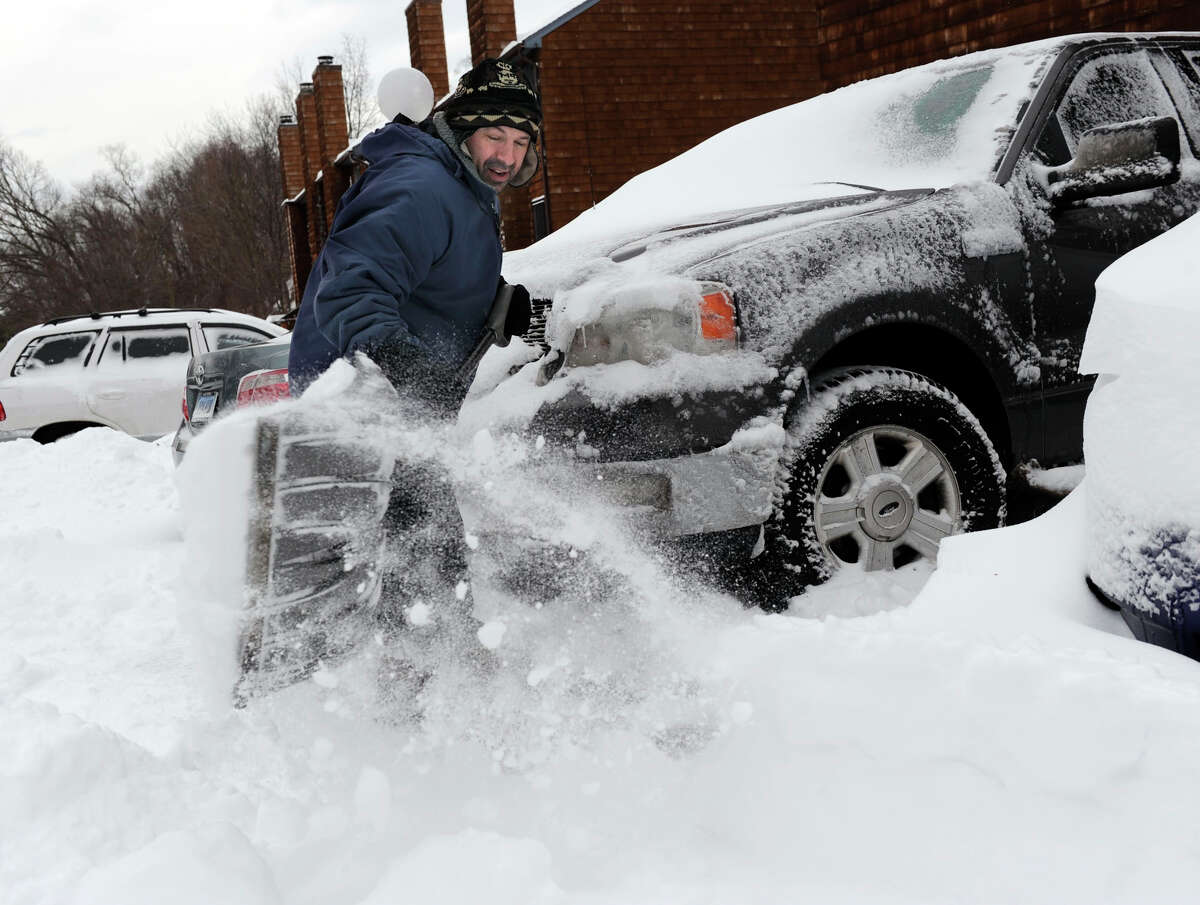 Richard Effinger, 43, of Danbury, digs his truck out from the snow Saturday morning, February 9, 2013.