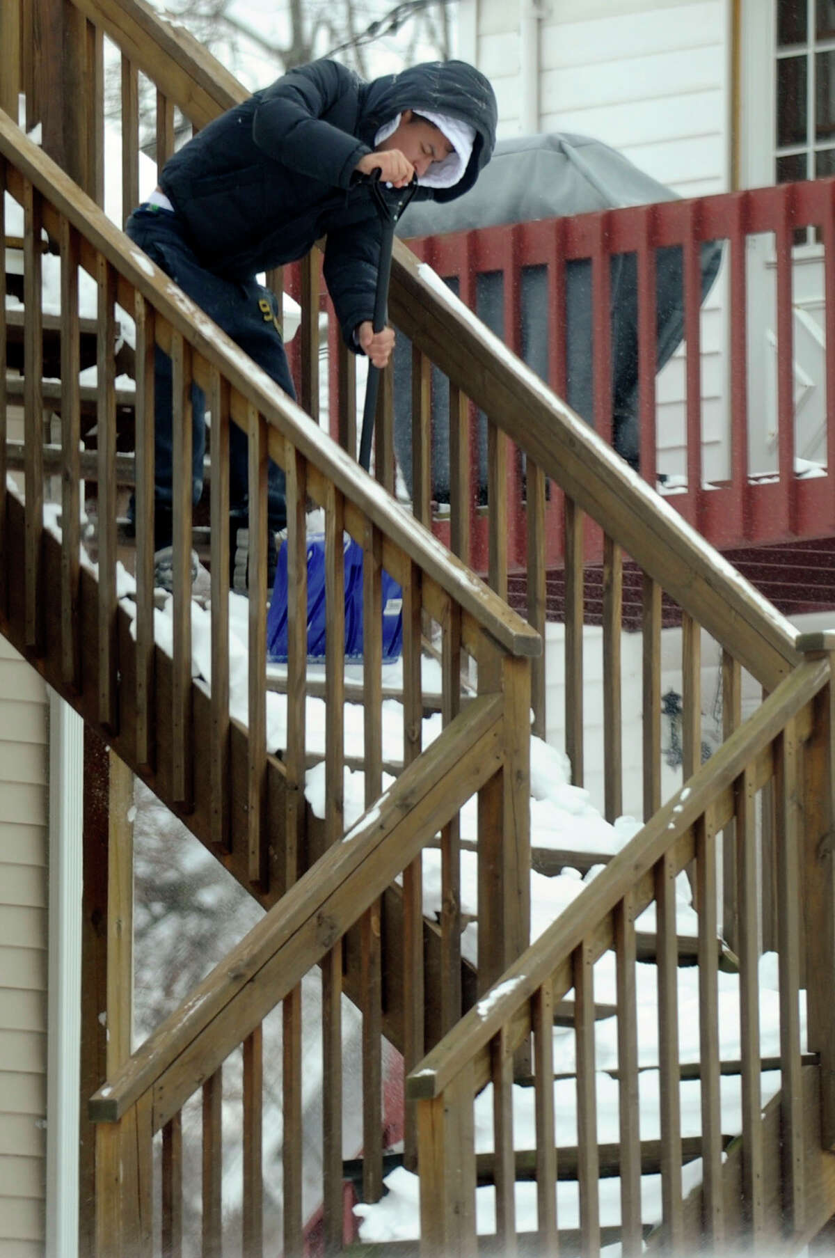 A man clears the steps from his home in Danbury, Conn. Saturday morning, February 9, 2013. A blizzard dumped almost two feet of the snow in the area Friday and Saturday.
