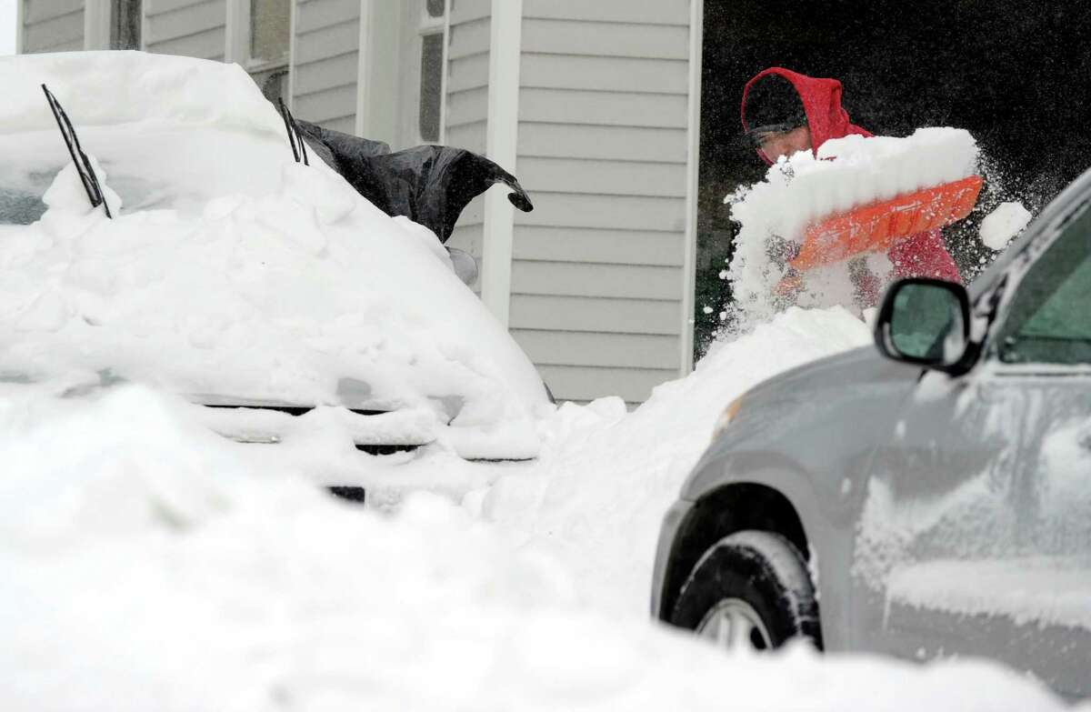 Walter Lojar, of Danbury, Conn. digs his car out Saturday morning, Feb. 9, 2013, from the almost two feet of snow dumped on the area by Friday and Saturday's blizzard.