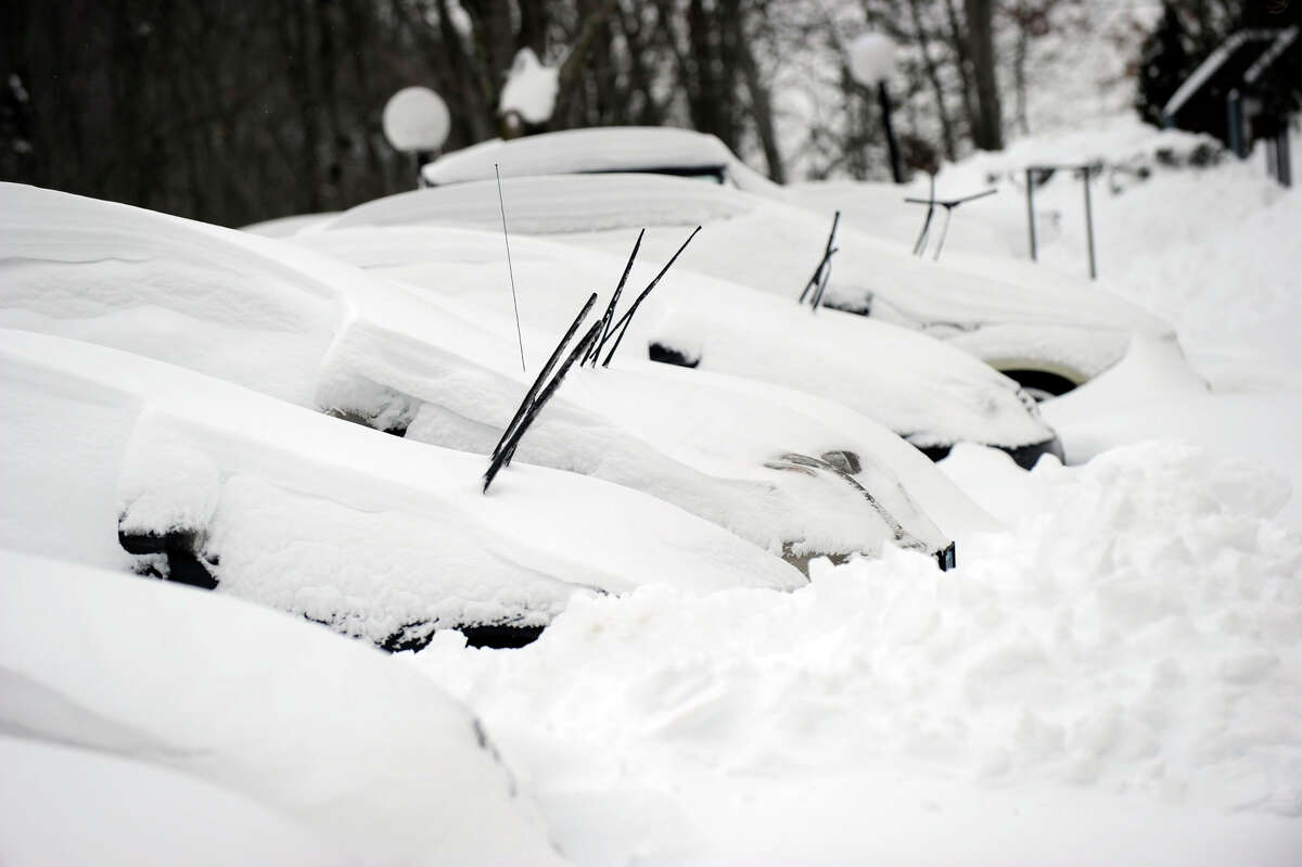 In a scene repeated all over the area this morning, cars are buried in snow at the Sheperd Hill Condominiums in Danbury early Saturday morning, Feb. 9, 2013. A blizzard Friday into Saturday dumped almost two feet of snow.