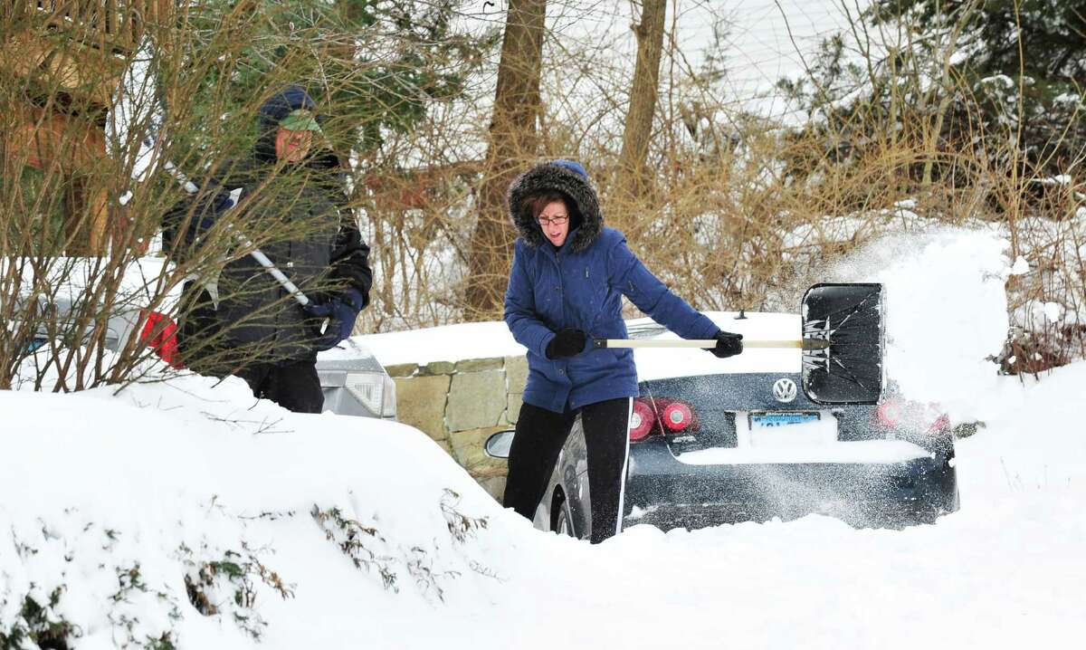 Frank and Mary Oleksvik dig out of the snow in Danbury Saturday, Feb. 9, 2013.