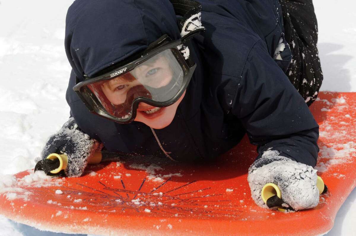 Five-year-old Ewan MacNaughton of Albany enjoys a sled ride at Capital Hills Golf Course on Saturday Feb. 9, 2013 in Albany, N.Y. .(Michael P. Farrell/Times Union)