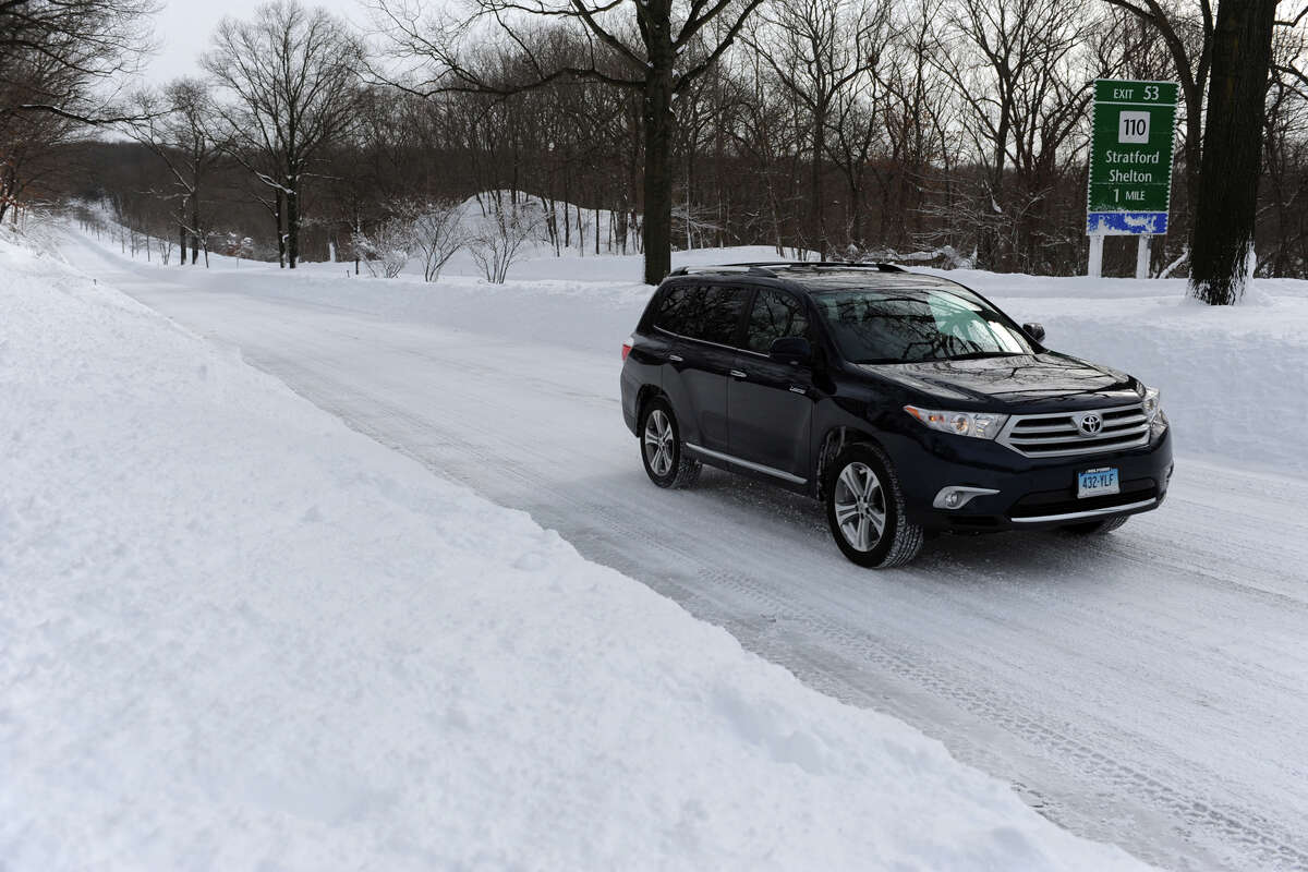 A lone vehicle travels on the Merritt Parkway, in Stratford, Conn., Feb. 9th, 2013. All road in Connecticut are closed Saturday due to the massive amounts of snow.