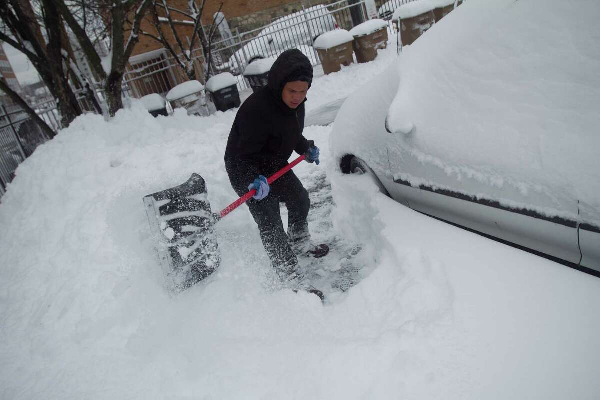 Danny Escobar clears a path in a parking lot on Stamford's West Side dig out from the blizzard on Saturday, Feb. 9, 2013.