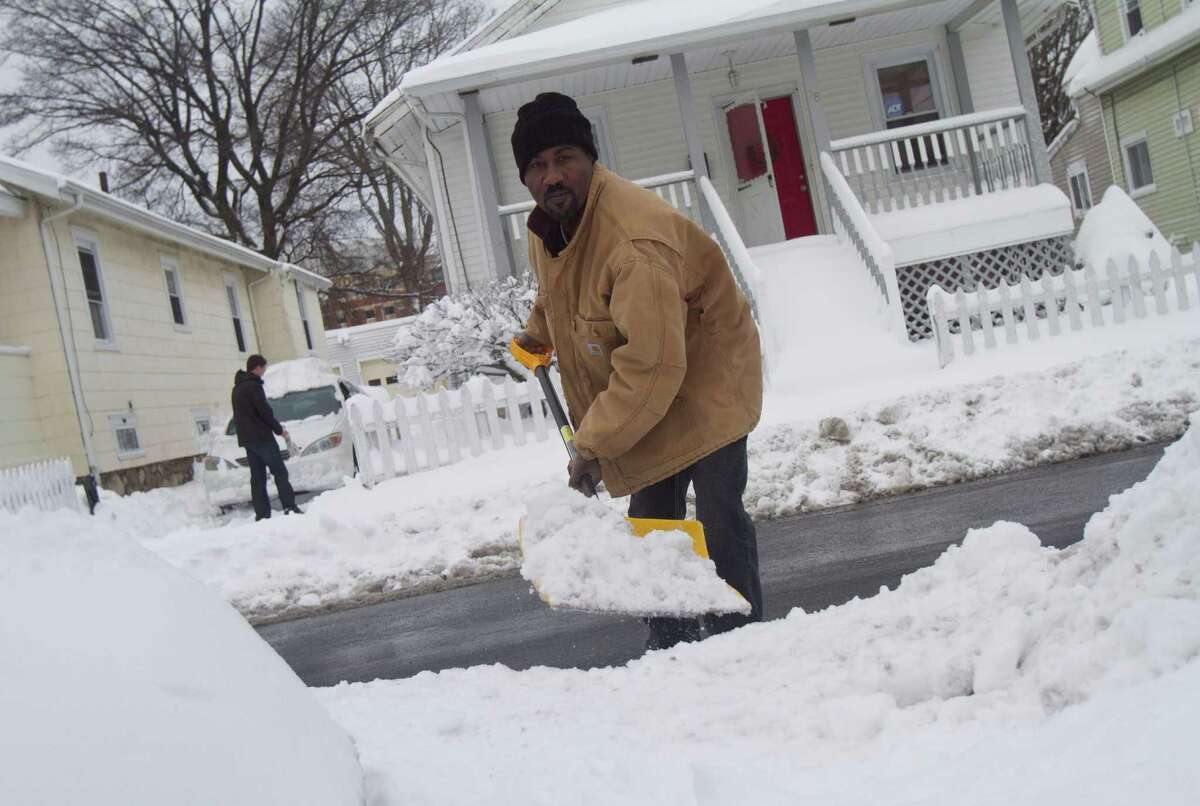 Nigel Pryce, a resident of Stamford's West Side digs out from the blizzard on Saturday, Feb. 9, 2013.