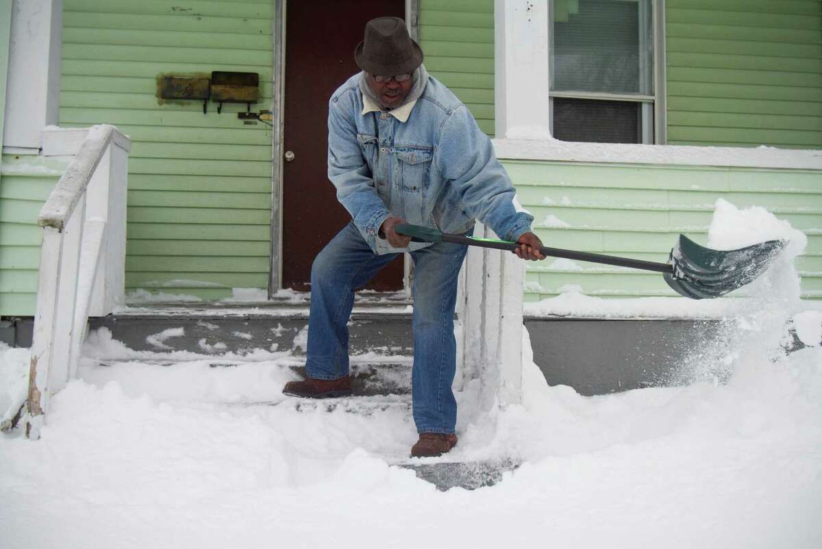 Andre Valentine, a resident of Stamford's West Side digs out from the blizzard on Saturday, Feb. 9, 2013.