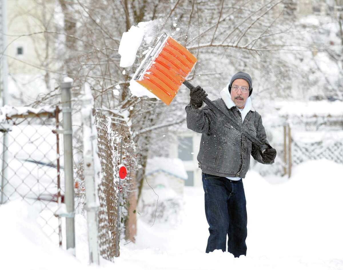 Luis Herrera clears snow from his South Water Street home in Byram during the aftermath of the blizzard that hit Greenwich, Conn., Saturday morning, Feb. 9, 2013.