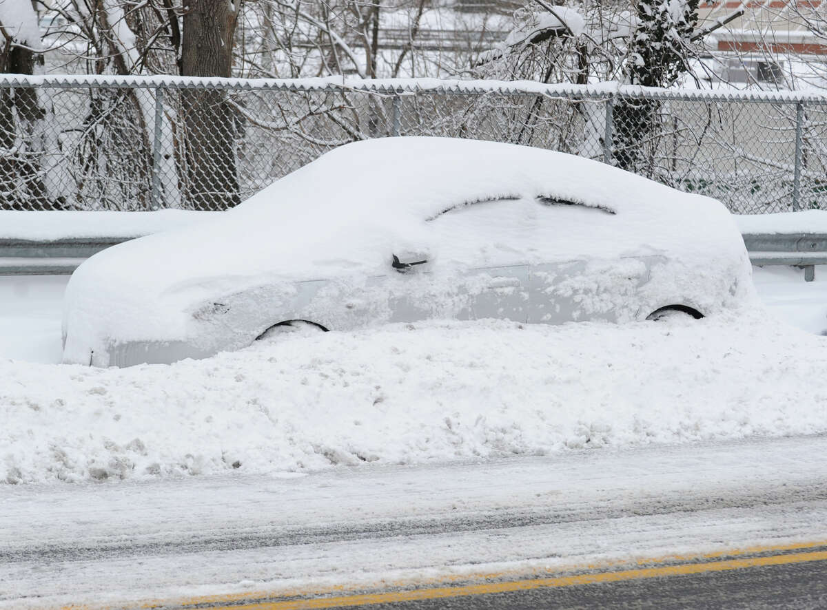 A car covered with snow on Byram Road during the aftermath of the blizzard that hit Greenwich, Conn., Saturday morning, Feb. 9, 2013.