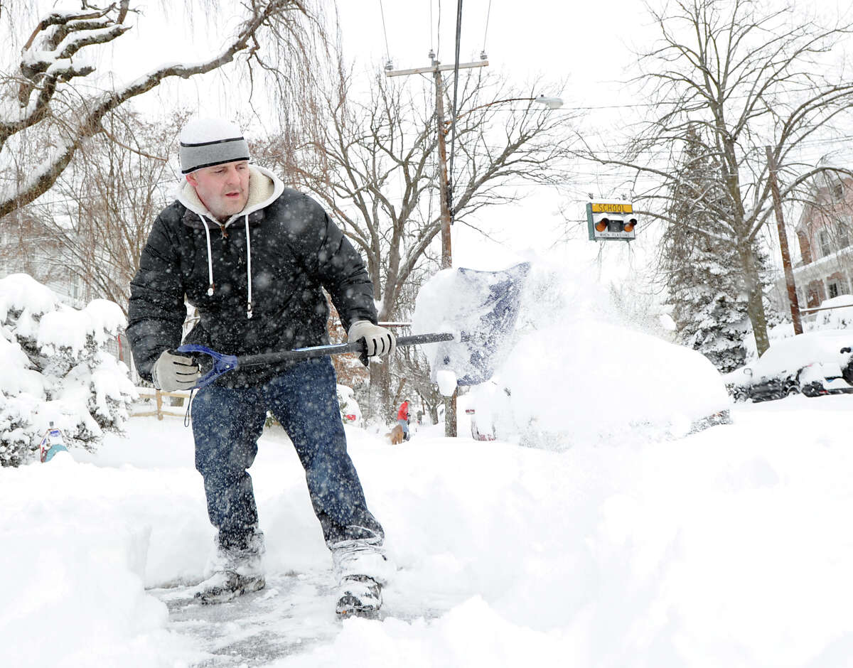 A man shovels snow on Mead Avenue during the aftermath of the blizzard that hit Greenwich, Conn., Saturday morning, Feb. 9, 2013.