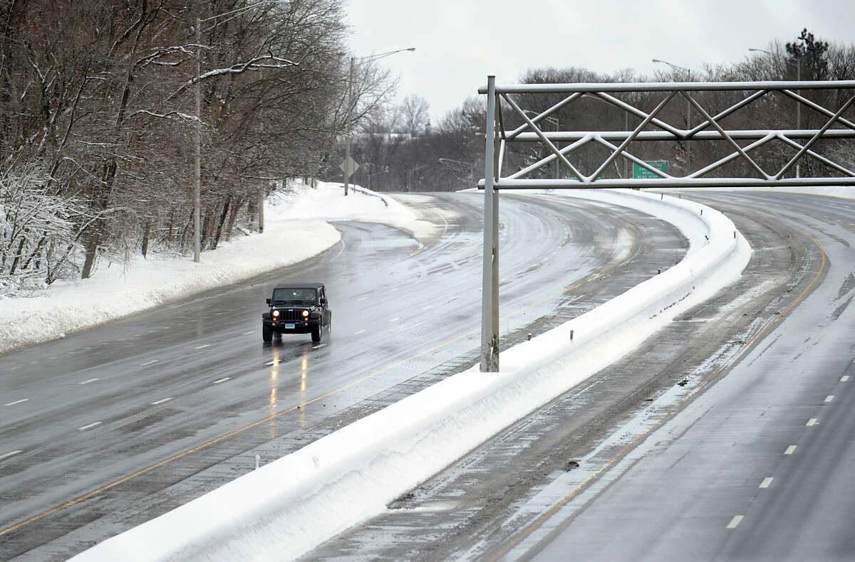 A lone vehicle heads south on a clear I-95 during the aftermath of the blizzard in Greenwich, Conn., Saturday morning, Feb. 9, 2013.