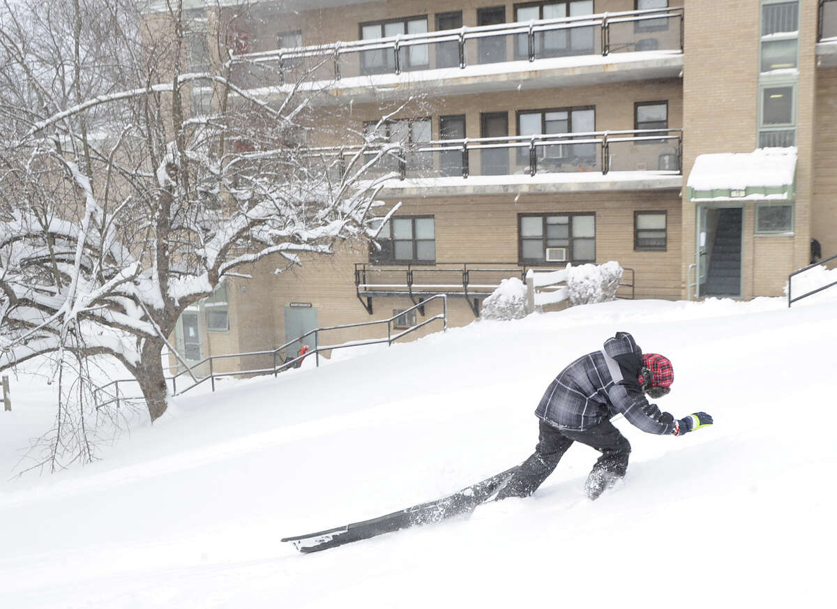 Daniel Estrella, 9, struggles to pull his sled up a hill during the aftermath of the blizzard at the Armstrong Court Public Housing Complex, Greenwich, Conn., Saturday morning, Feb. 9, 2013.
